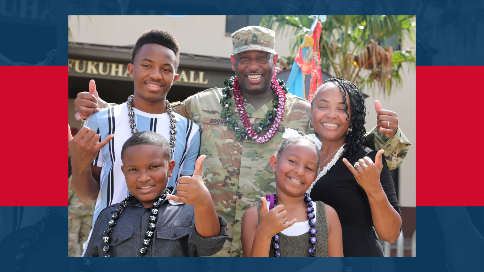 Military family hugging and smiling.